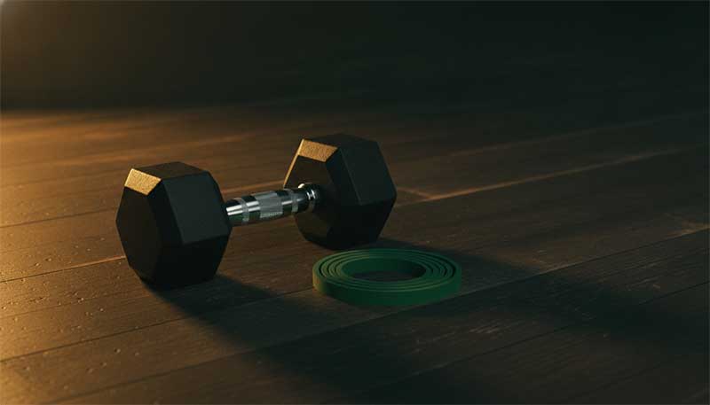 Dumbbell and resistance band representing exercise strategies during GLP-1 treatment
