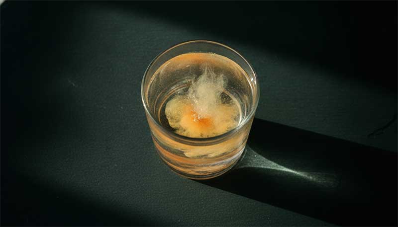 A glass of water with electrolytes, representing hydration-based hangover support