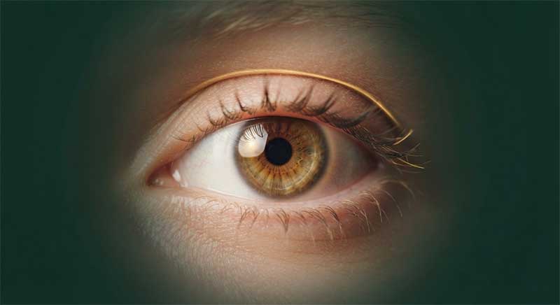 Close-up of a healthy human eye with soft golden light
