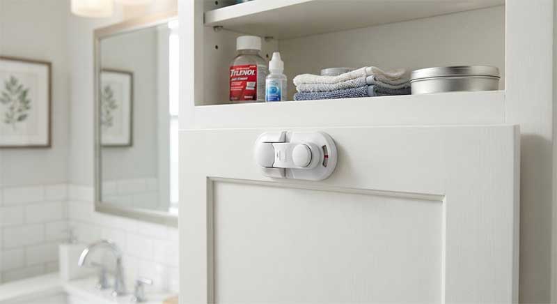A high bathroom cabinet shelf with a visible child safety lock