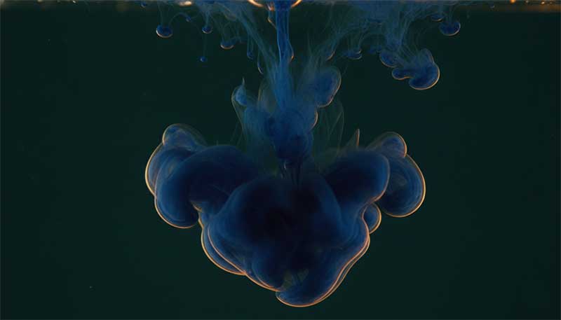 Blue dye dispersing in water, representing methylene blue's electron transfer mechanism