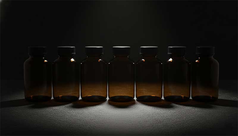 Six mushroom supplement bottles in a row